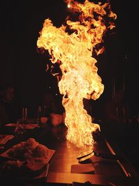 Flaming pan on restaurant table