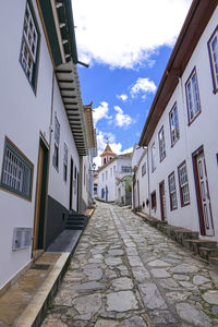 Footpath amidst buildings in city