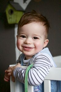 Close-up portrait of cute boy in crib