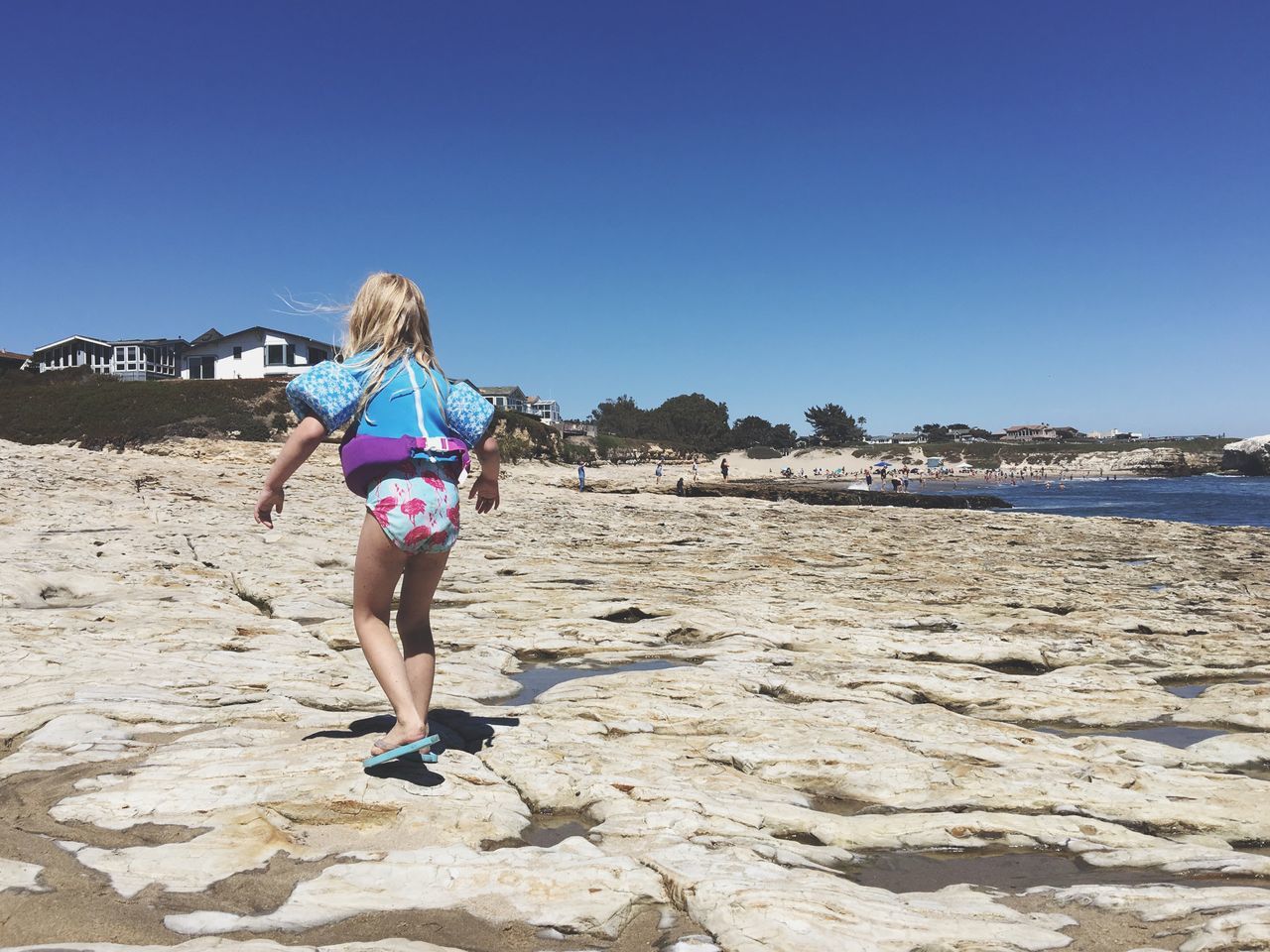 WOMAN STANDING ON BEACH