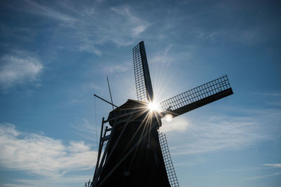 Low angle view of windmill against sky