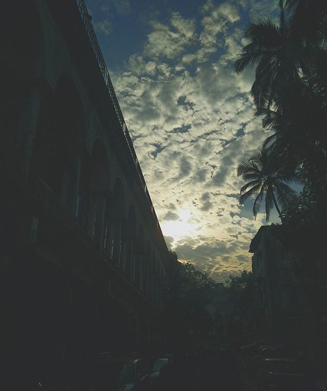 architecture, built structure, building exterior, sky, low angle view, cloud - sky, silhouette, building, tree, dusk, cloud, outdoors, cloudy, no people, history, city, day, old, nature, residential building