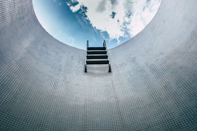 Digital composite image of staircase and building against sky