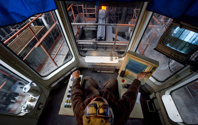 Directly above shot of man working in steel factory