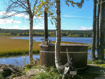 Calm lake with trees in background