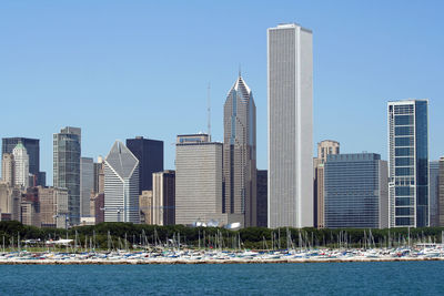 Modern buildings in city against clear sky