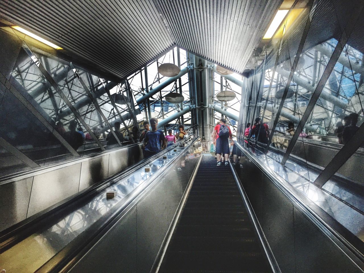 ceiling, public transportation, modern, lifestyles, escalator, the way forward, transportation building - type of building, diminishing perspective, subway station, leisure activity, interior, subway, illuminated, journey, city life, day, vanishing point