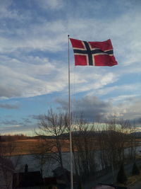 American flag against cloudy sky