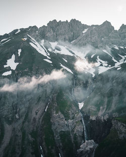 Aerial view of snowcapped mountains against sky