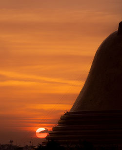 The buddha house pagoda bigness of thailand. two man sitting and relax with sunset background