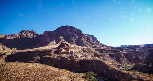 Scenic view of mountains against clear blue sky