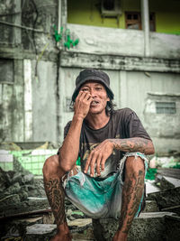 Portrait of man sitting outdoors