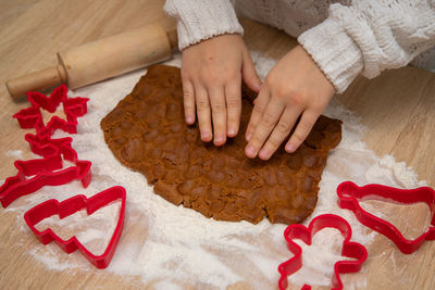 Gingerbread dough for christmas cookies and cookie cutters.