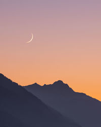 Scenic view of silhouette mountains against sky during sunset
