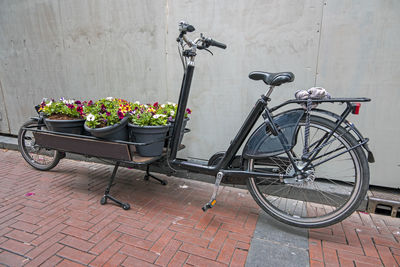 Bicycle on footpath against wall