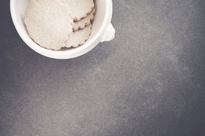 Directly above shot of biscuits in white bowl on table