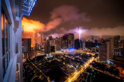 High angle view of illuminated buildings against sky at night