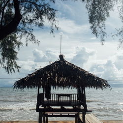 Gazebo on beach against sky