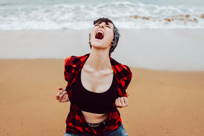 Mid adult woman standing at beach