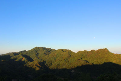 Scenic view of mountains against clear blue sky