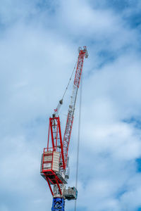 Low angle view of crane against sky