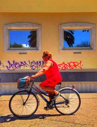 Woman riding bicycle on city street