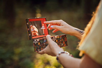 Childhood trauma in adults. outdoor portrait of woman holding a music box in her hands