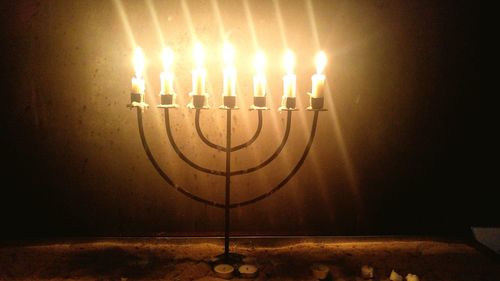 Illuminated candles on table