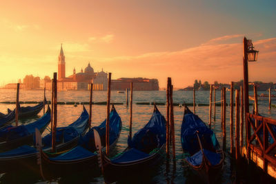 Boats in river at sunset