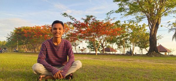 Bright in the middle of grass and red leafy trees