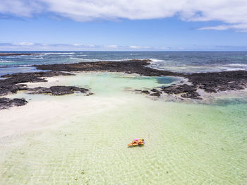 Aerial view of woman swimming in sea