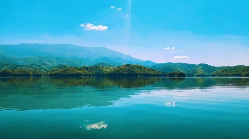 Scenic view of lake against blue sky