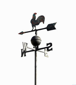 Low angle view of weather vane against clear sky