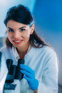 Biology student researcher looking through the microscope