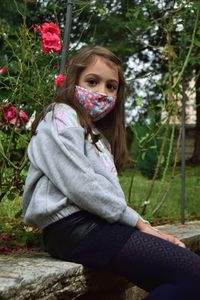Portrait of girl sitting on plant