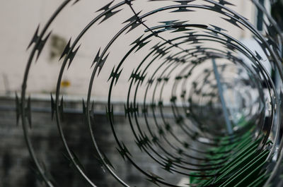 Close-up of spiral wire against sky