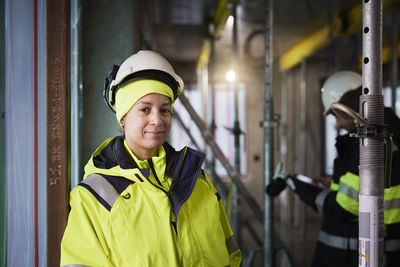 Portrait of smiling female engineer at construction site