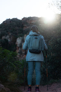 Woman contemplates the mountain ready to take on the challenge of climbing it.