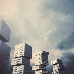 Low angle view of modern building against cloudy sky