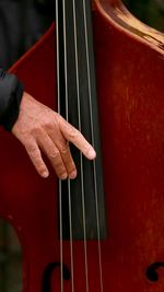 Cropped hand playing double bass