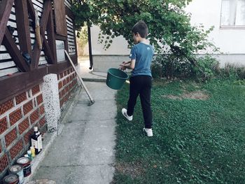 Full length of boy on plants against trees