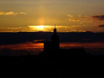 Silhouette of built structure at sunset