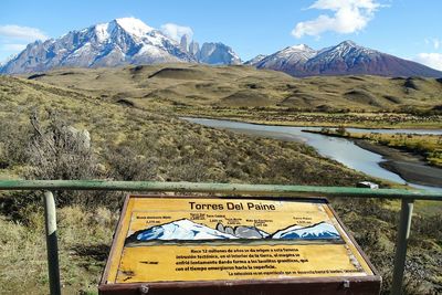 Sign board against lake and mountains at torres del paine national park