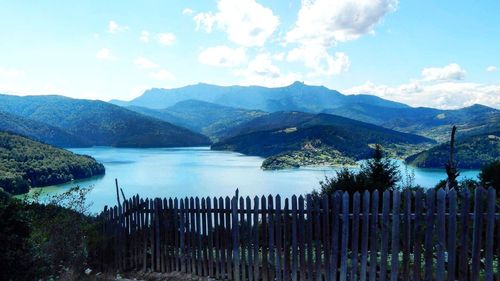 Scenic view of lake and mountains against sky