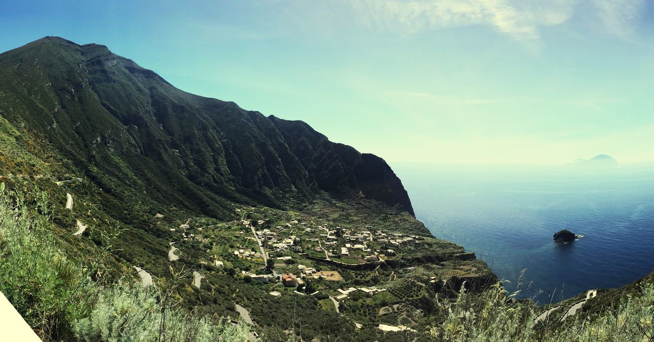 water, mountain, sea, scenics, tranquil scene, sky, tranquility, beauty in nature, nature, mountain range, high angle view, aerial view, horizon over water, idyllic, lake, landscape, transportation, day, coastline, outdoors