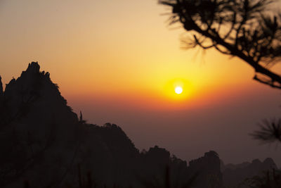 Scenic view of silhouette mountains against sky during sunset