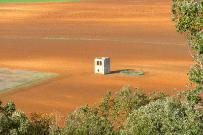 High angle view of building and trees on field