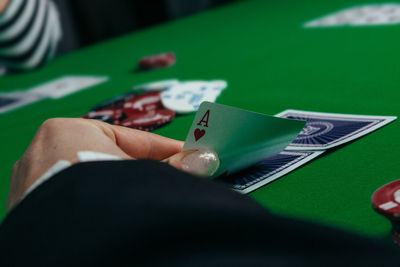 Close-up of hand holding book on table