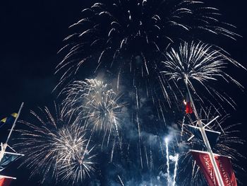 Low angle view of firework display at night