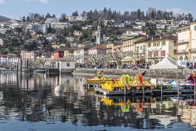 Panorama of ascona with houses with colorful facades reflecting on lake maggiore